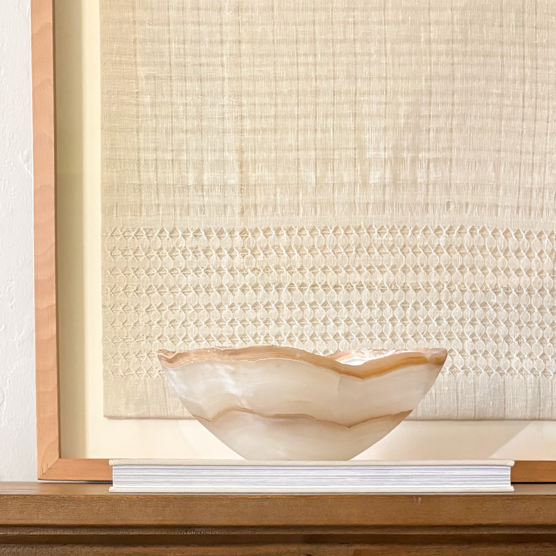 Artisan hand carved amber onyx bowl showcasing unique banded stone design
