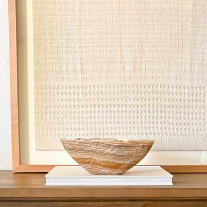 Handcrafted amber onyx bowl with organic patterns and elegant design