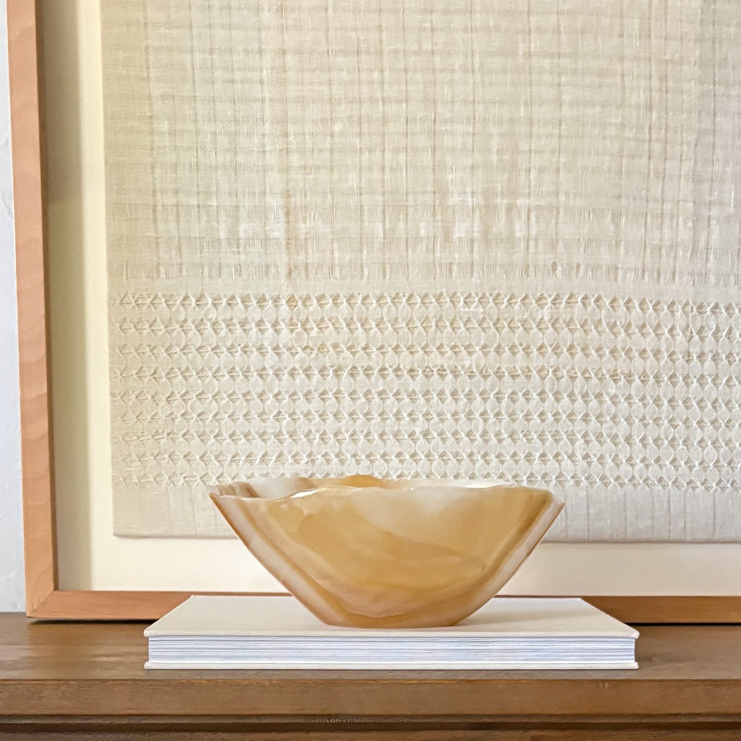 Decorative stone bowl for entryway table styling with natural amber tones