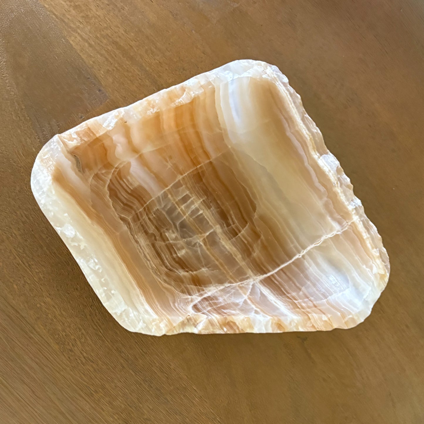 Hand carved onyx bowl in warm amber tones elegant stone home decoration