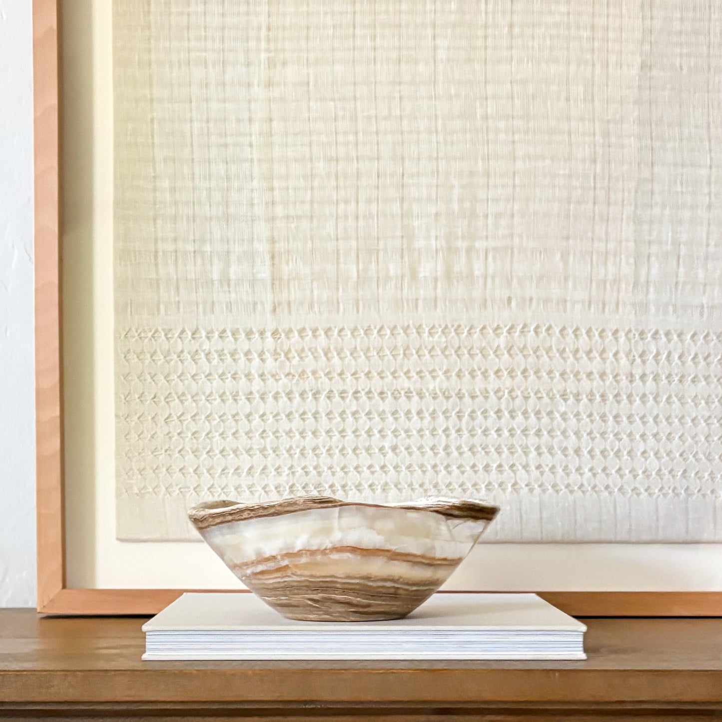 Handcrafted amber onyx bowl with smooth finish, unique stone centerpiece