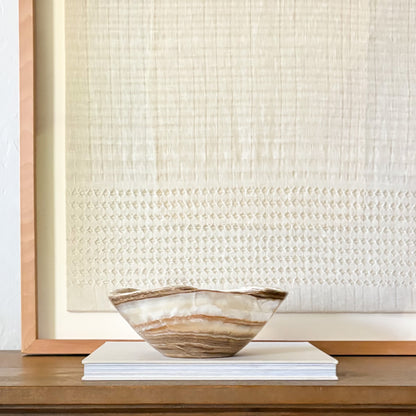 Handcrafted amber onyx bowl with smooth finish, unique stone centerpiece