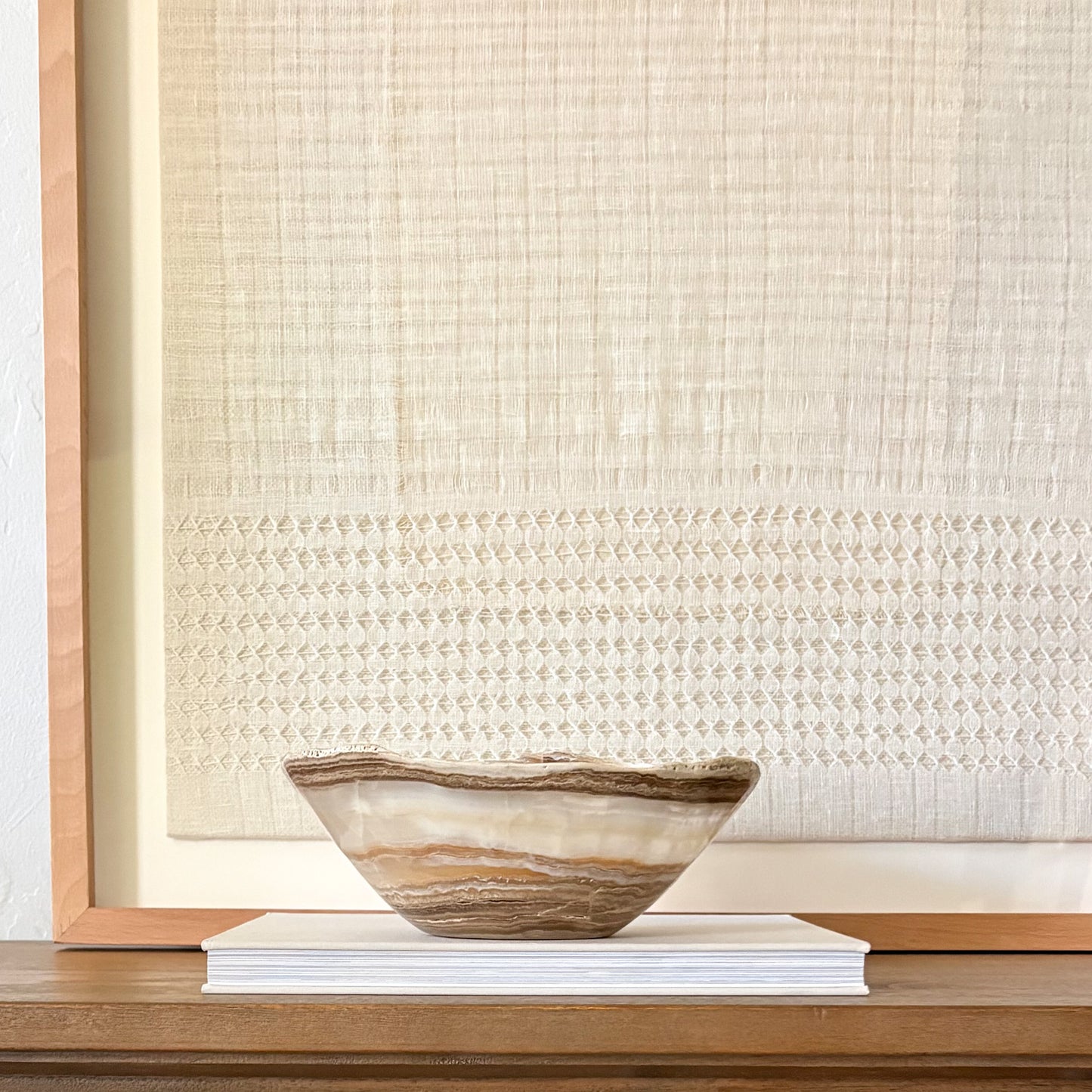 Hand-carved amber onyx bowl featuring natural stone veining and polished artisan craftsmanship