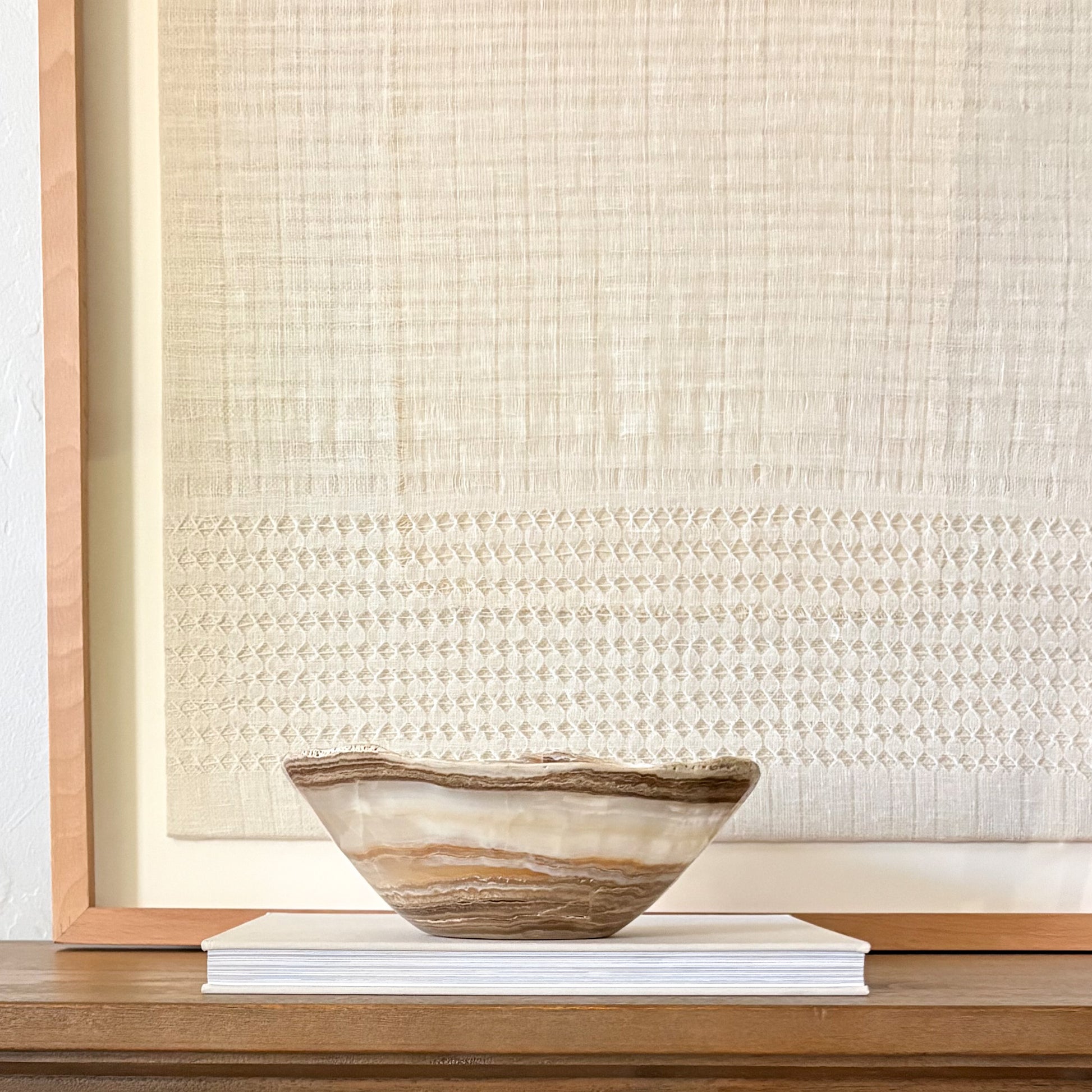 Hand-carved amber onyx bowl featuring natural stone veining and polished artisan craftsmanship