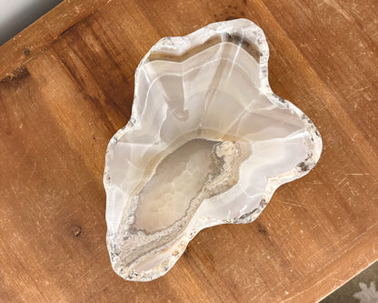 Amber onyx stone bowl with unique natural banding and veining