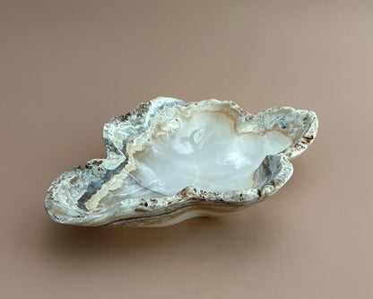 Hand-carved amber onyx bowl featuring warm golden tones, rich caramel veining, and natural stone variations