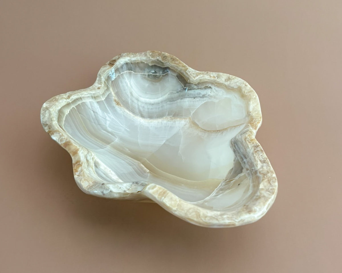 Hand-carved amber onyx bowl featuring warm golden tones, rich caramel veining, and natural stone variations