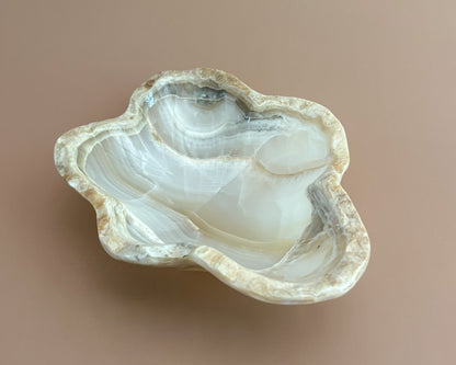 Hand-carved amber onyx bowl featuring warm golden tones, rich caramel veining, and natural stone variations