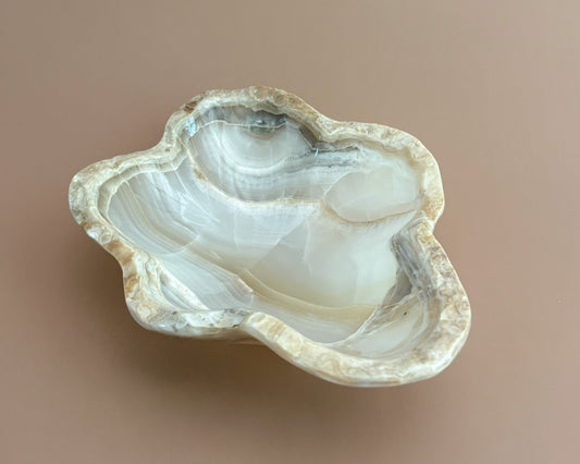 Hand-carved amber onyx bowl featuring warm golden tones, rich caramel veining, and natural stone variations