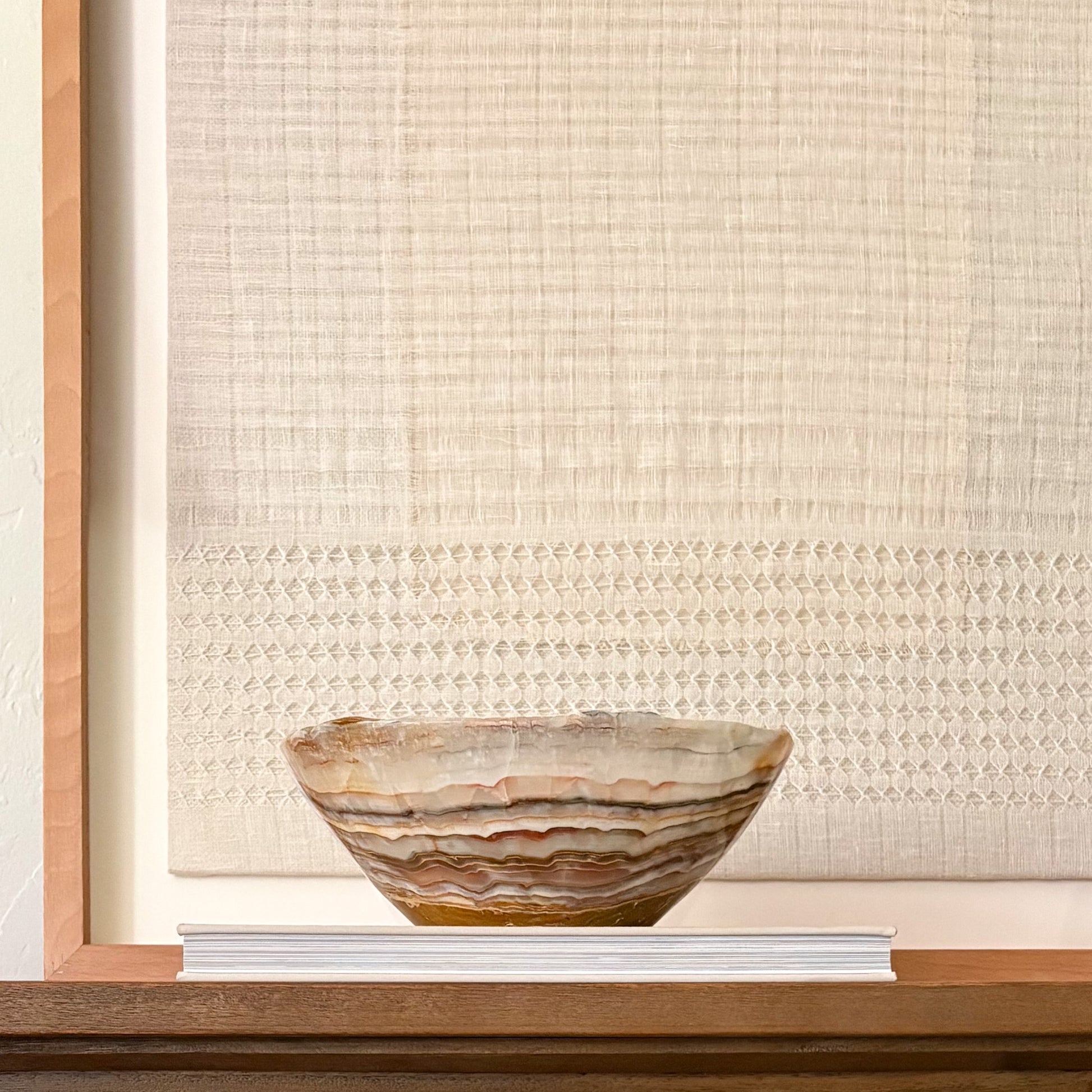 Artisan hand carved onyx bowl in warm brown tones