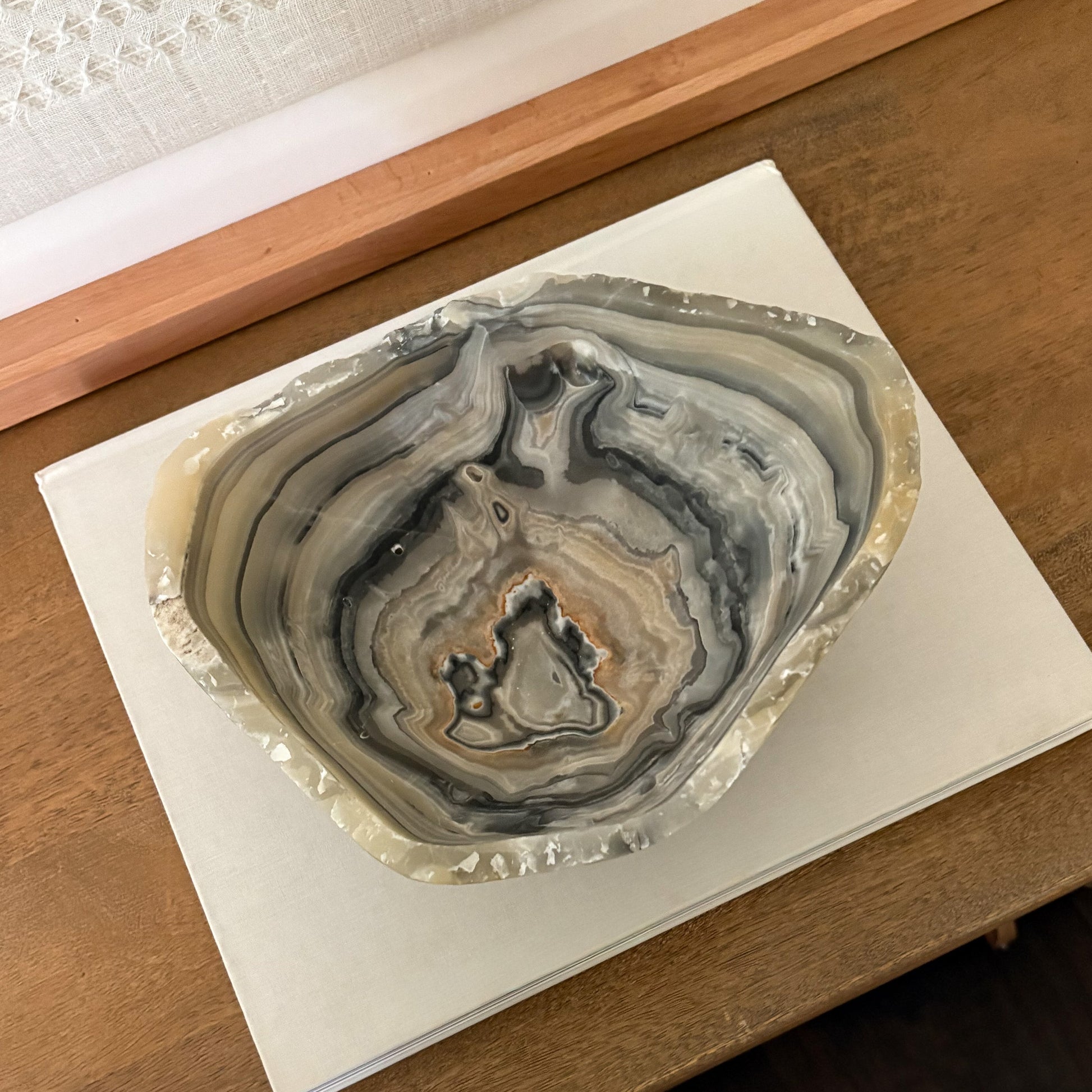 Decorative grey onyx bowl on minimalist shelf styling