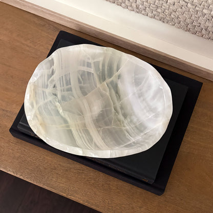 Decorative white onyx bowl with polished finish and natural veining