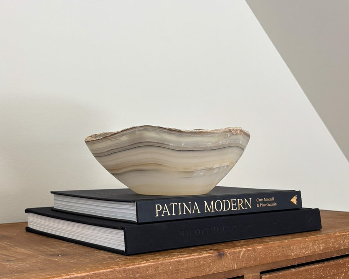 Sculptural grey onyx bowl featuring organic stone patterns and a polished finish.