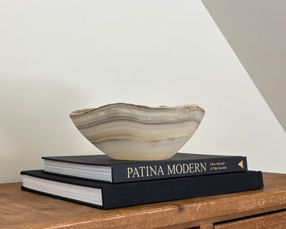 Sculptural grey onyx bowl featuring organic stone patterns and a polished finish.