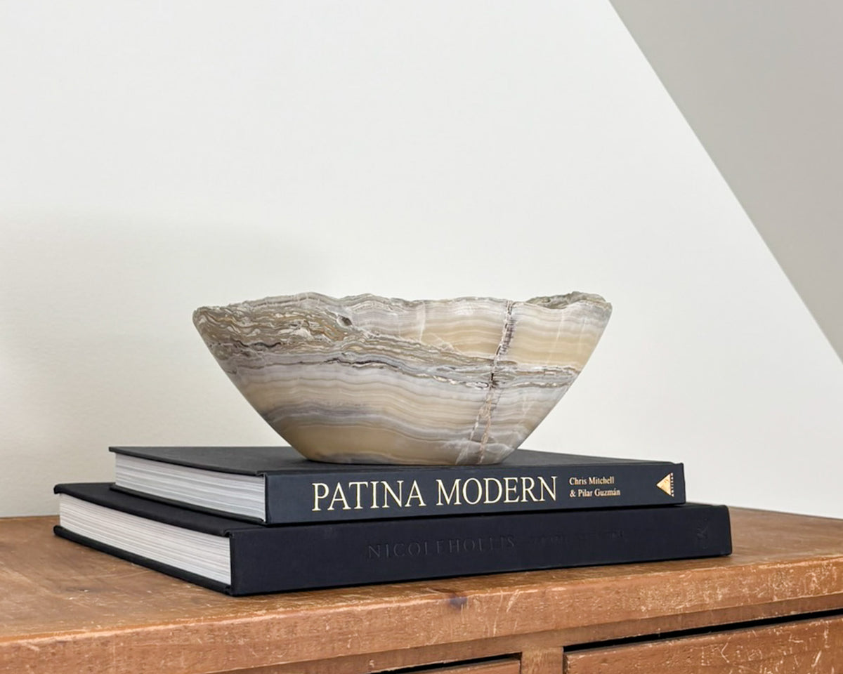 One-of-a-kind grey onyx bowl with natural mineral banding and a smooth, polished surface.