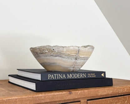 One-of-a-kind grey onyx bowl with natural mineral banding and a smooth, polished surface.