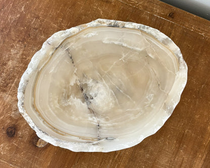 Natural grey onyx stone bowl with contrasting shades of charcoal and soft grey