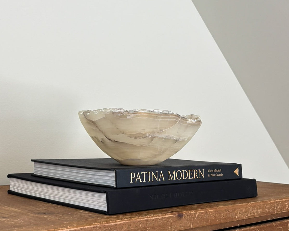 Side profile of grey onyx decorative bowl showing organic shape and natural banding