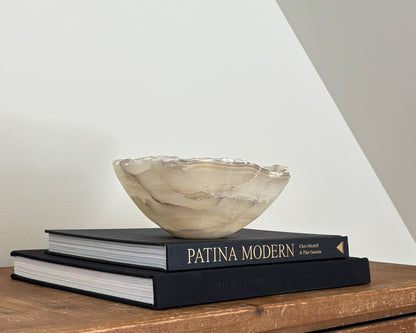 Side profile of grey onyx decorative bowl showing organic shape and natural banding