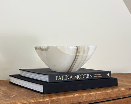 Decorative grey onyx stone bowl featuring organic patterns and polished finish