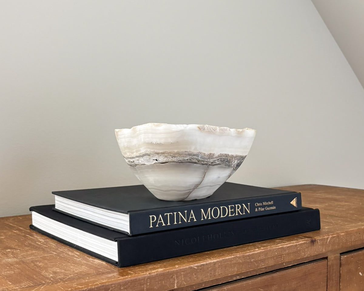 Polished grey onyx bowl featuring unique mineral patterns and tonal variations