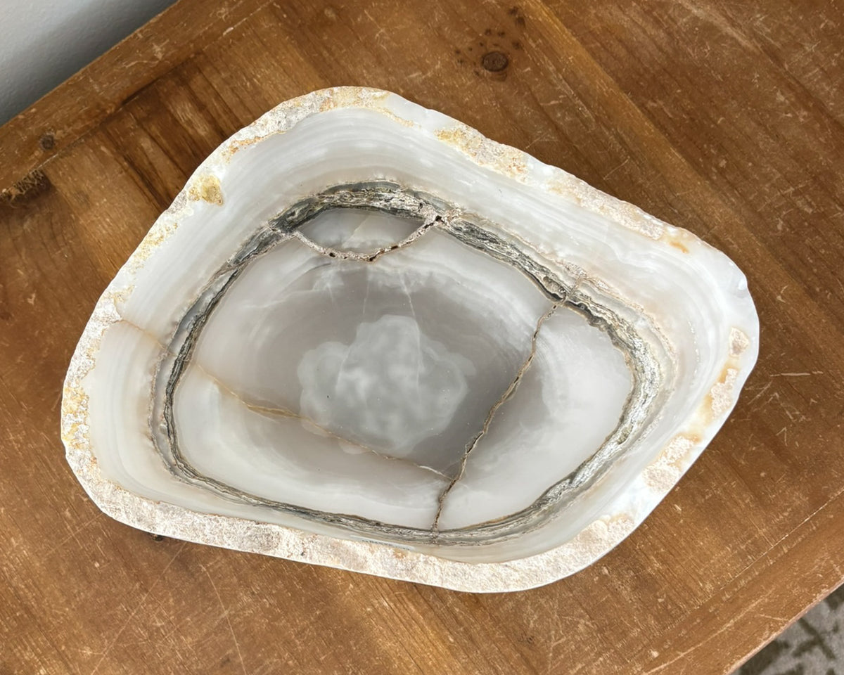 Artisan-carved grey onyx bowl with distinctive natural banding