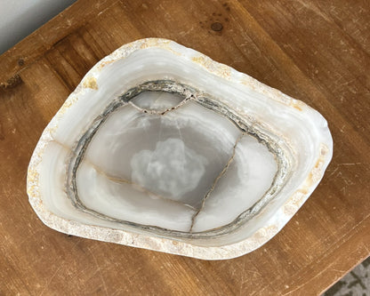Artisan-carved grey onyx bowl with distinctive natural banding