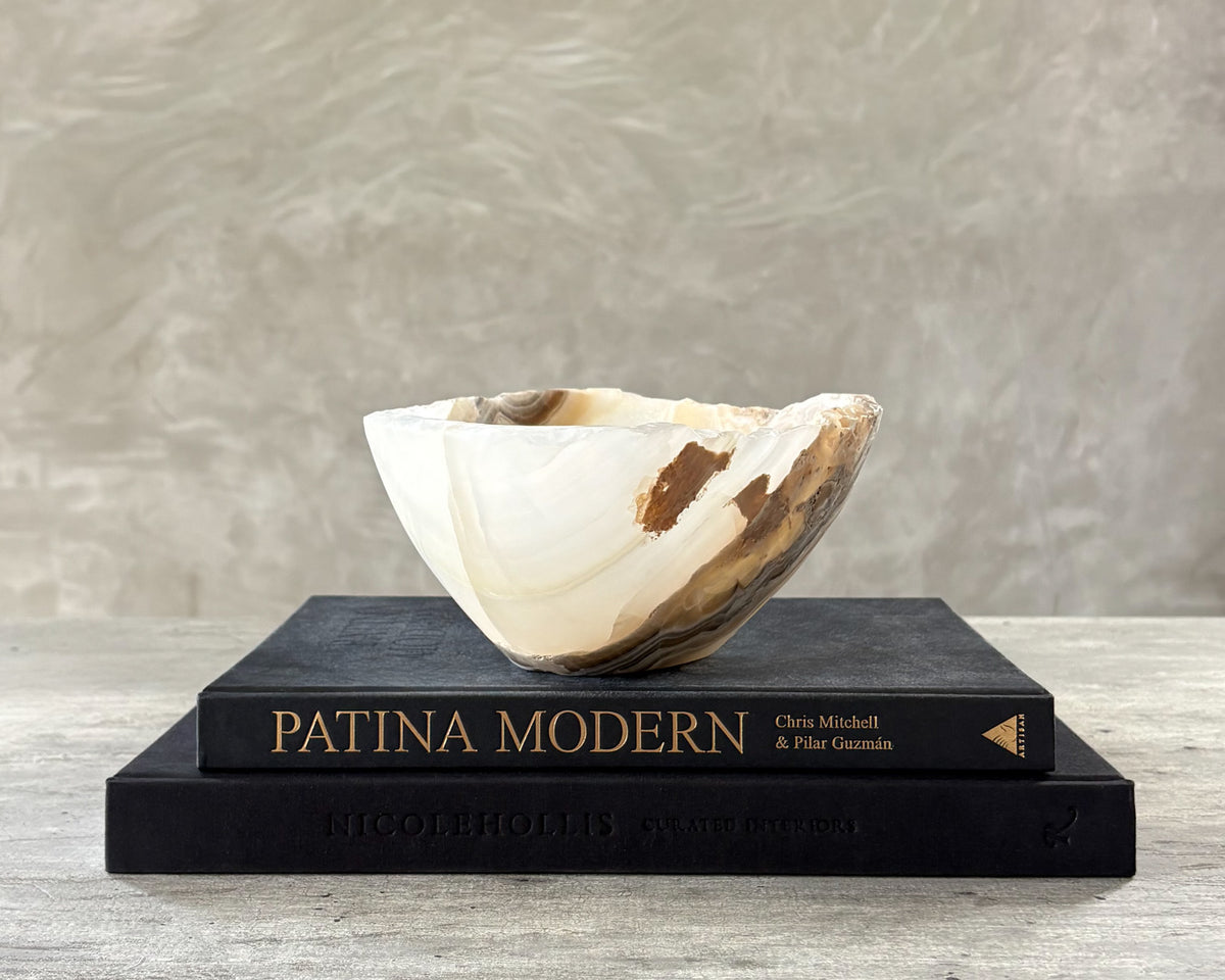Polished grey onyx bowl with distinctive mineral veining and organic shape