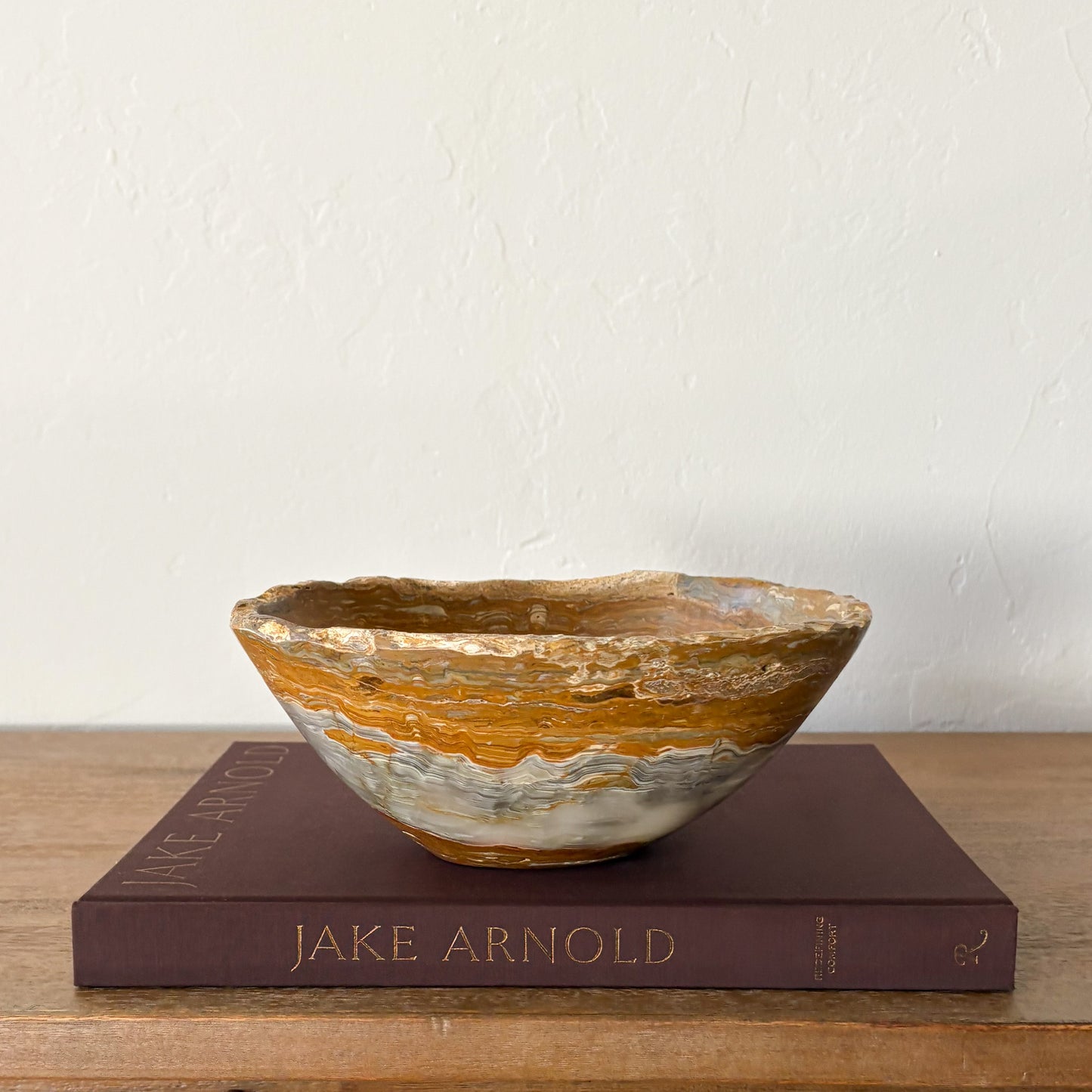 Artisan carved grey onyx stone bowl styled on modern wood console