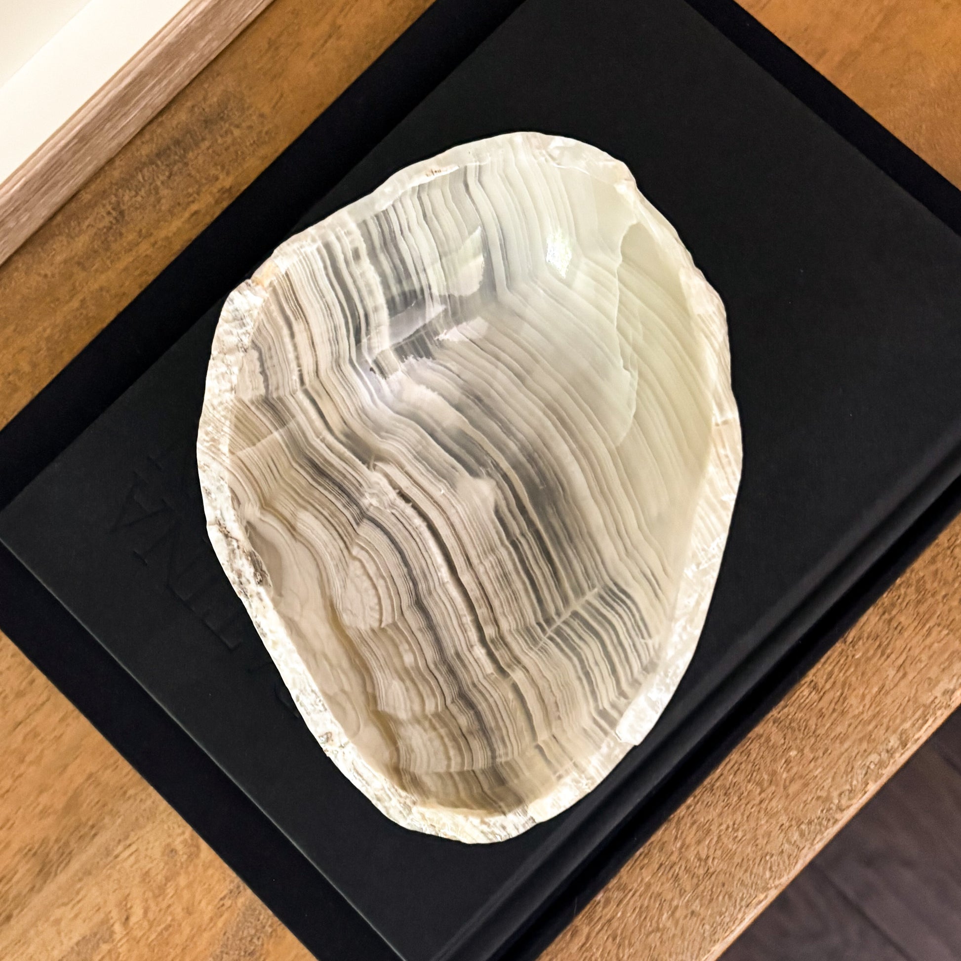 Small hand-carved grey onyx bowl with smooth polished surface and distinctive stone patterns