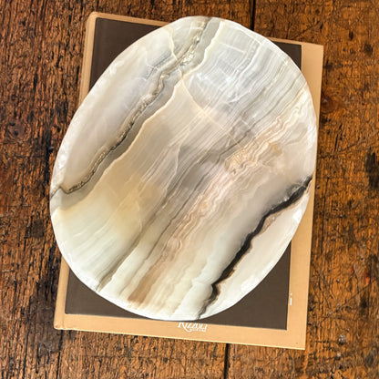 Sculpted grey onyx bowl with organic stone textures and variations