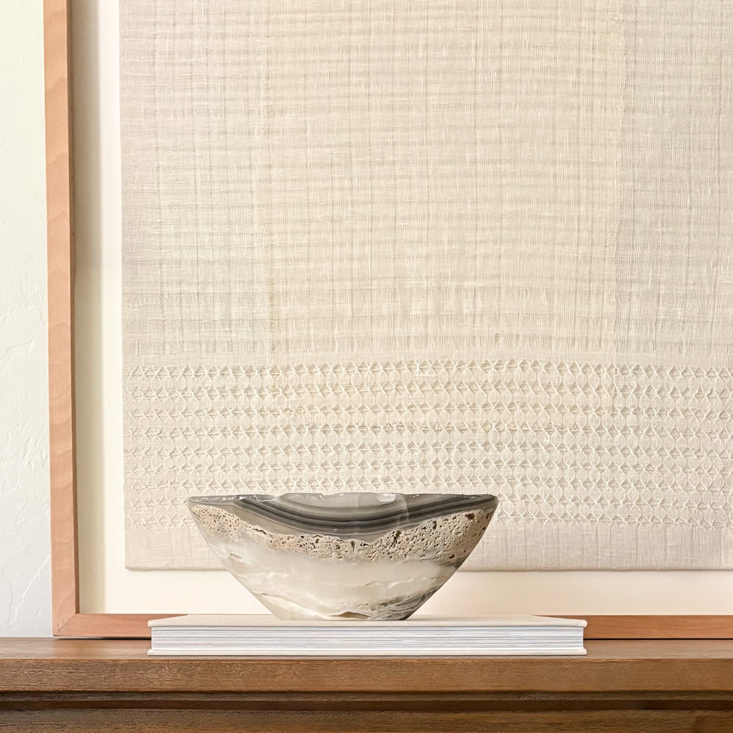 Sculptural grey onyx bowl showcasing unique veining and hand-carved craftsmanship.
