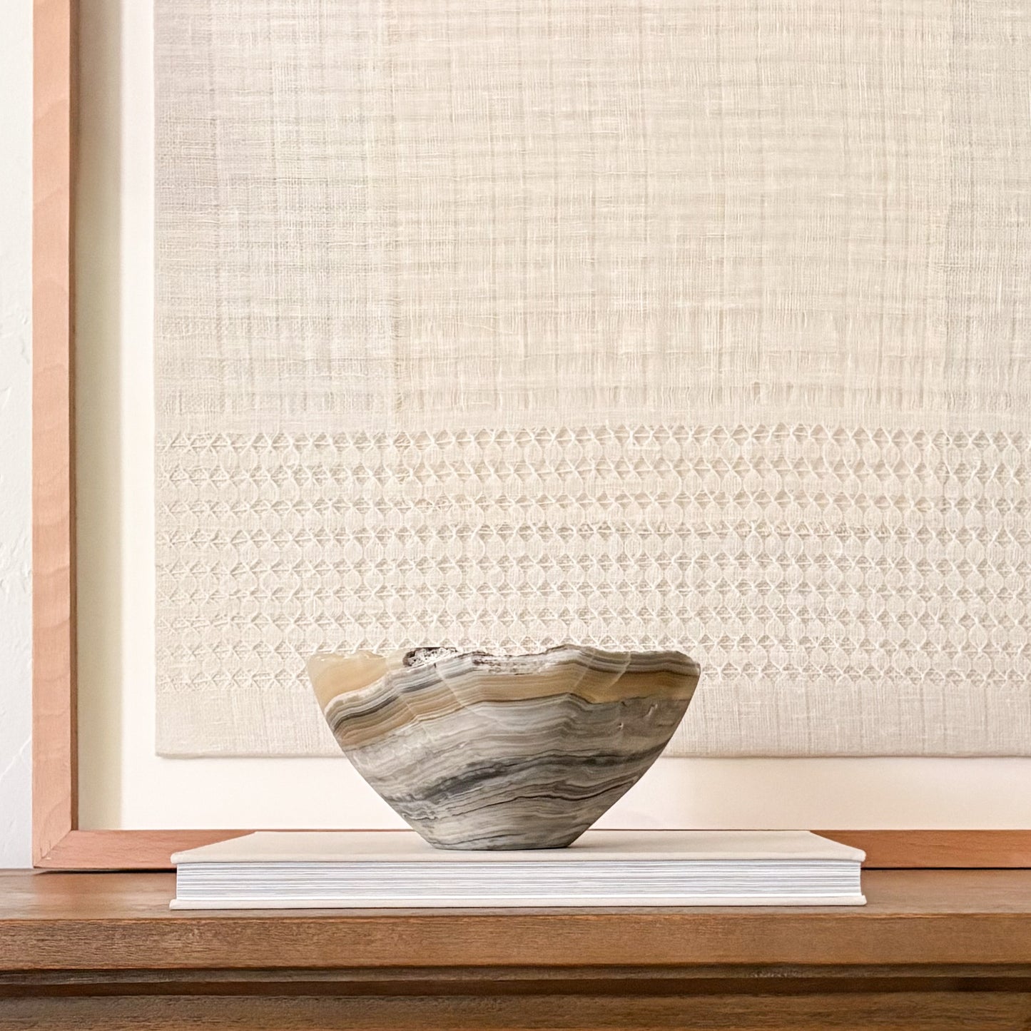 Sculptural grey onyx bowl showcasing unique veining and hand-carved craftsmanship.