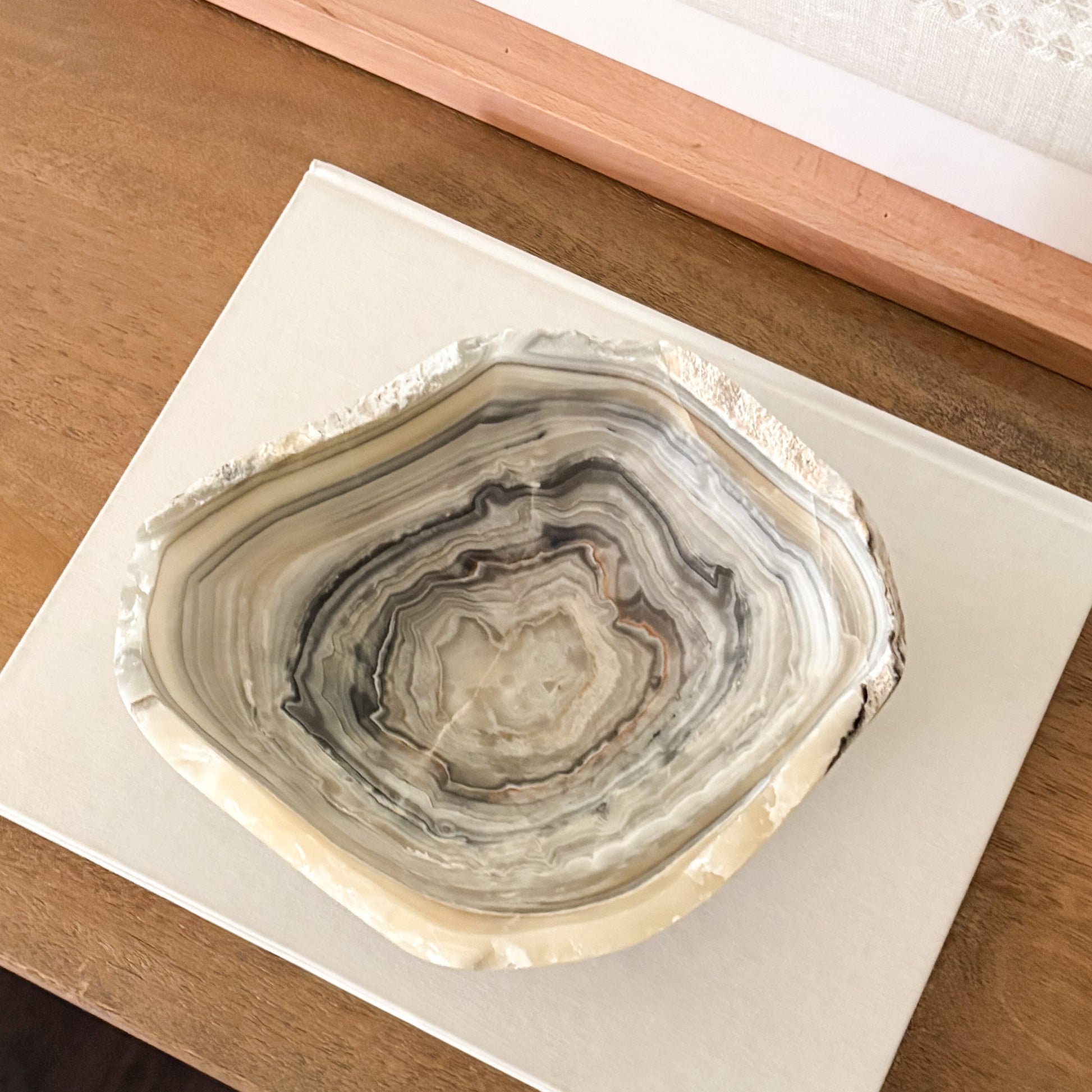 Elegant grey onyx bowl carved from solid natural stone for modern home décor.