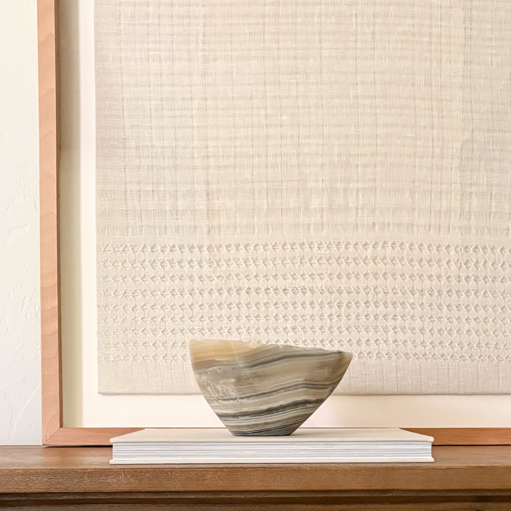 One-of-a-kind hand-carved grey onyx bowl ideal for coffee tables, consoles, and shelves.
