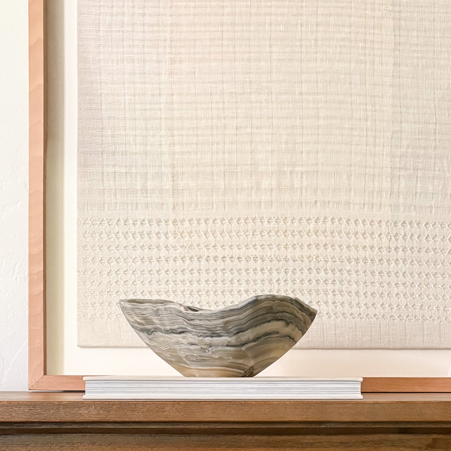 Sculptural grey onyx bowl showcasing unique veining and hand-carved craftsmanship.