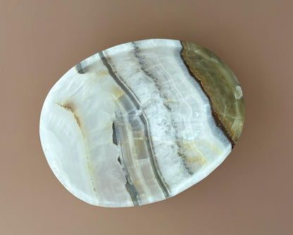 Interior of olive onyx decorative bowl showing natural stone banding and unique mineral patterns