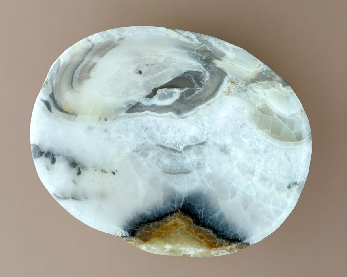 Interior of olive onyx decorative bowl showing natural stone banding and unique mineral patterns