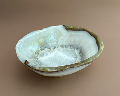 Interior of olive onyx decorative bowl showing natural stone banding and unique mineral patterns