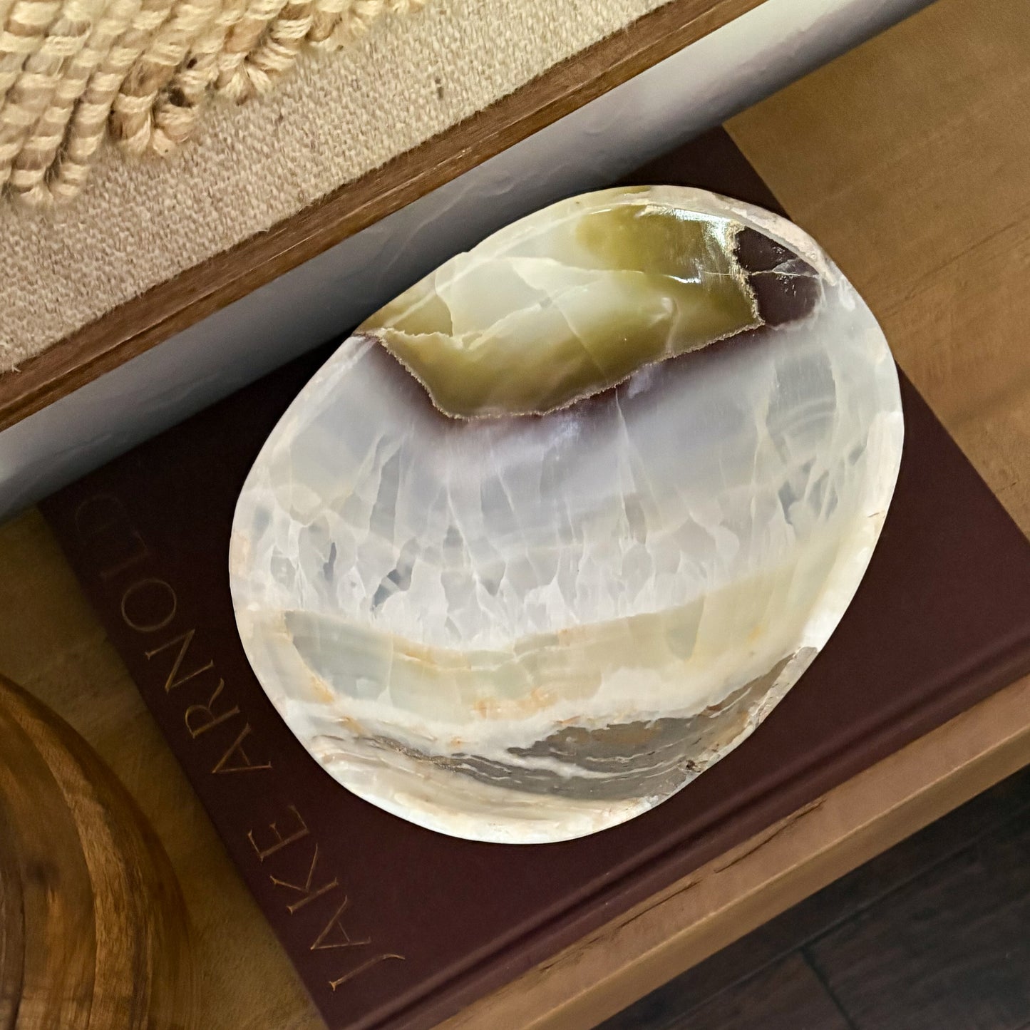 Olive onyx accent bowl paired with neutral modern decor