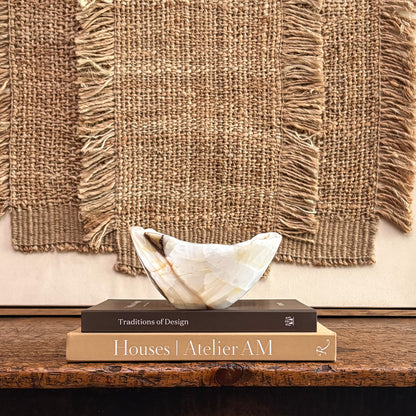 Natural stone olive onyx bowl displayed on console table with elegant decor