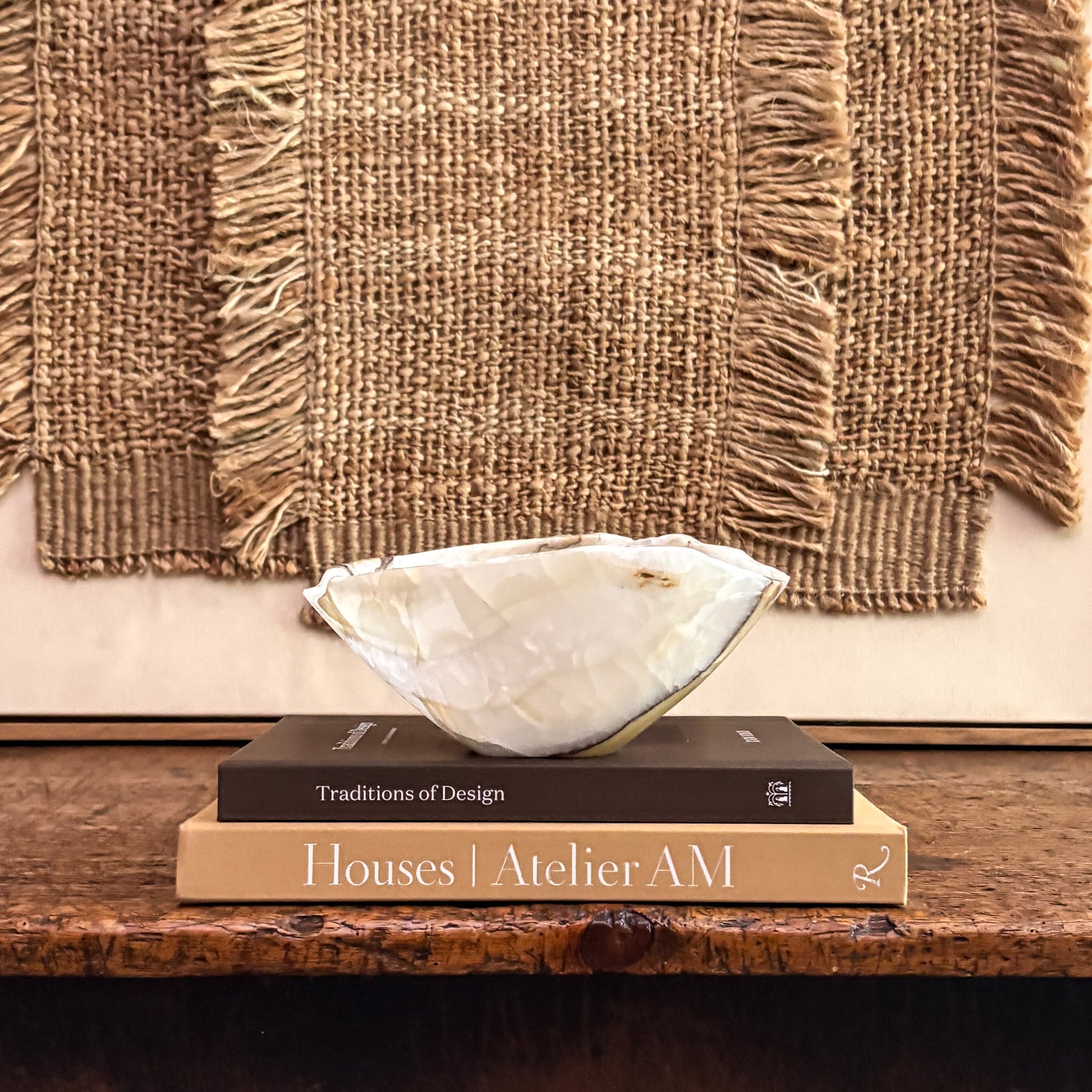 Hand carved olive onyx bowl styled on modern console table 