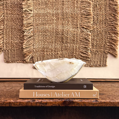 Hand carved olive onyx bowl styled on modern console table 