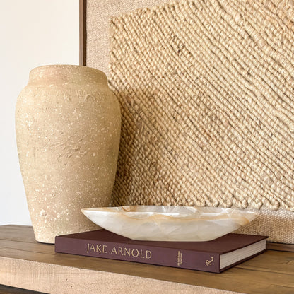 hand-carved white and amber onyx bowl with natural stone veining, decorative artisan stone bowl