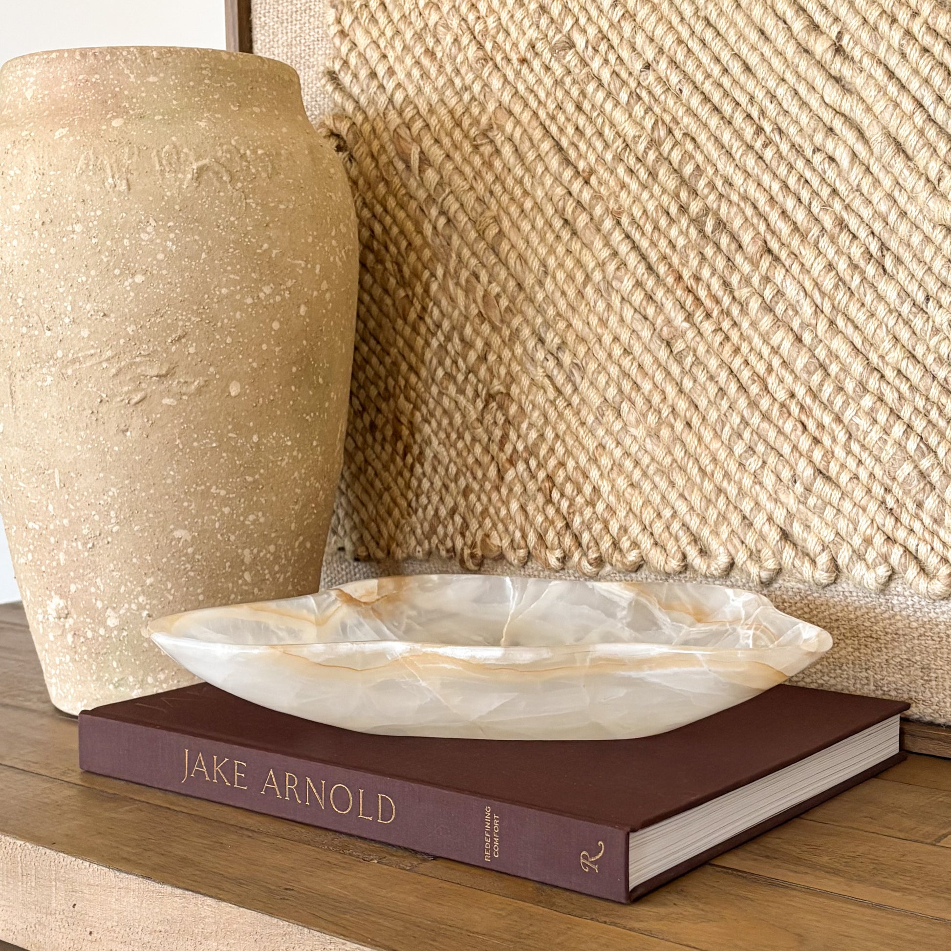 Hand carved white and amber onyx bowl styled as a luxury coffee table decor piece