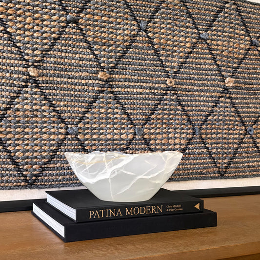 Hand-carved white onyx bowl with smooth polished finish and natural stone veining