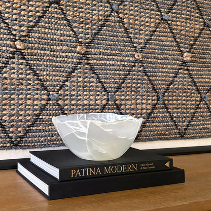 Hand-carved white onyx bowl with smooth polished finish and natural stone veining