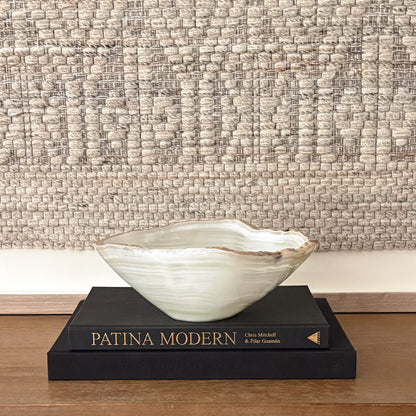 Round hand-carved white onyx bowl showcasing natural cream and ivory veining
