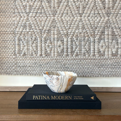 Artisan carved zebra calcite bowl in neutral tones styled for modern home decor