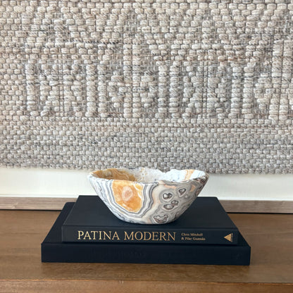 Sculptural zebra calcite bowl centerpiece with natural crystal formations and banded pattern